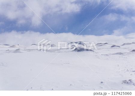highland snowy plateau, lifeless snowy landscape with hummocks 117425060