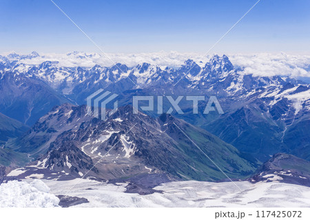 landscape of the high mountains above the clouds from the snowfield on the slope of Mount Elbrus 117425072