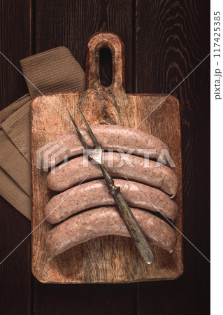 raw sausages in English with bacon, for grilling, on a cutting board, top view, no people, 117425385