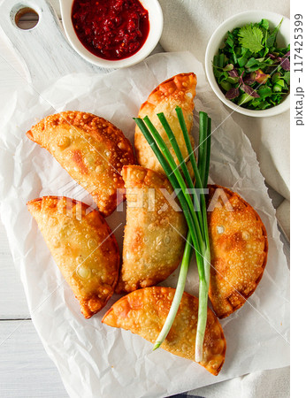 Fried chebureks, close-up, on a light background, no people, Fried chebureks, close-up, on a light background, no people, 117425399