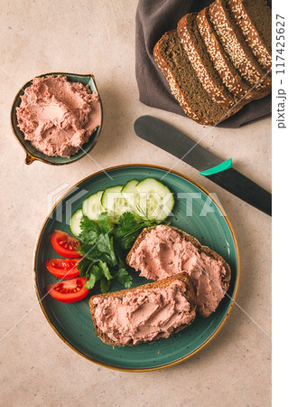 Liver meat pate spread on rye bread, breakfast, close-up, beige background. no people, selective focus, Liver meat pate spread on rye bread, breakfast, close-up, beige background. no people, selective focus, 117425627