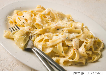 Fettuccine, tagliatelle, in creamy garlic sauce, Italian traditional cuisine, pasta carbonaro, Fettuccine, tagliatelle, in creamy garlic sauce, Italian traditional cuisine, pasta carbonaro, 117425636