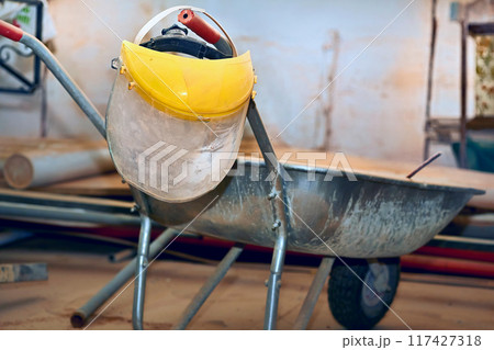 Plastic protective mask on construction metal wheelbarrow Plastic protective mask on construction metal wheelbarrow 117427318