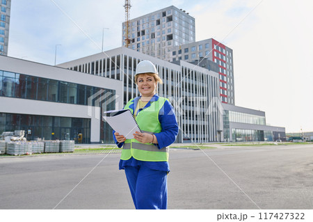 Confident mature female engineer developer inspector at construction site Confident mature female engineer developer inspector at construction site 117427322