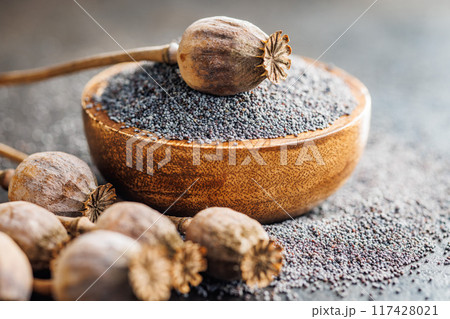 Dry head and poppy seed in bowl on kitchen table. Dry head and poppy seed in bowl on kitchen table. 117428021