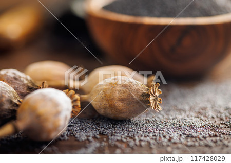 Dry poppy seed and poppy head on wooden table. Dry poppy seed and poppy head on wooden table. 117428029