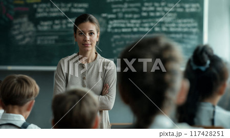 Female teacher. Portrait of a happy teacher in a classroom 117428251