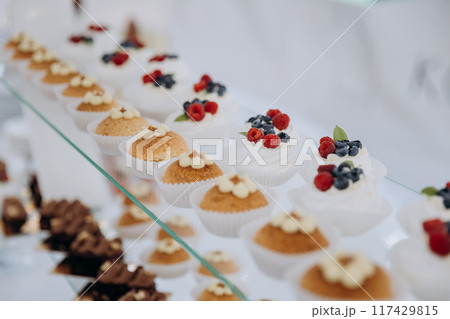 Set of delicious sweet cakes and dessert in the restaurant. Scene is celebratory and festive 117429815