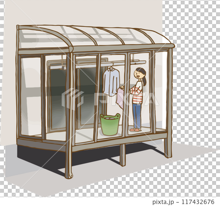 Woman hanging out laundry in sunroom 117432676