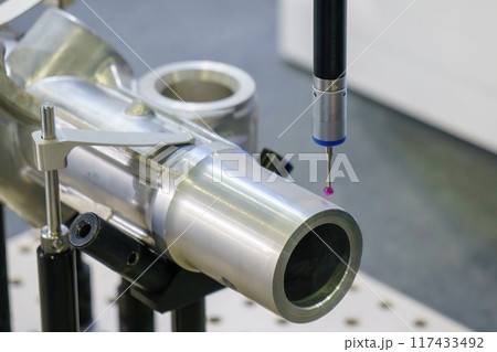 The  CMM probe measuring the  aluminum automotive parts. 117433492