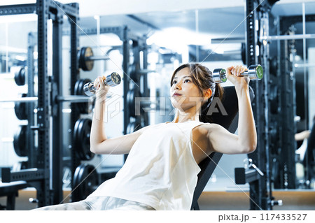 スポーツジムでトレーニングする若い女性 117433527