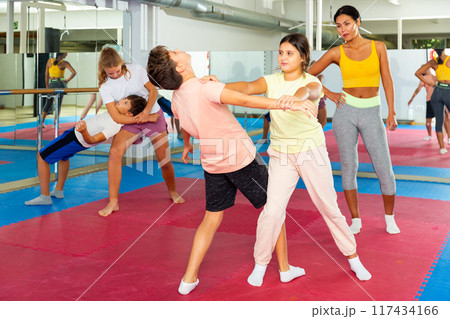 Kids in pair exercising self-defense movements 117434166