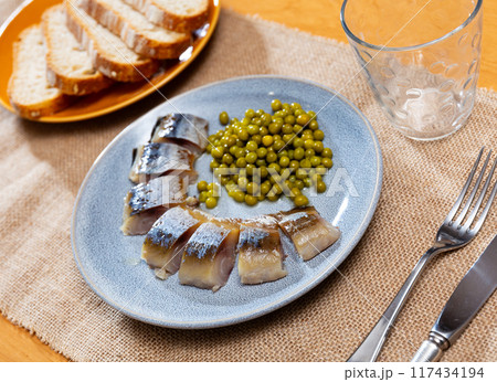 Sliced mackerel fish served with peas 117434194