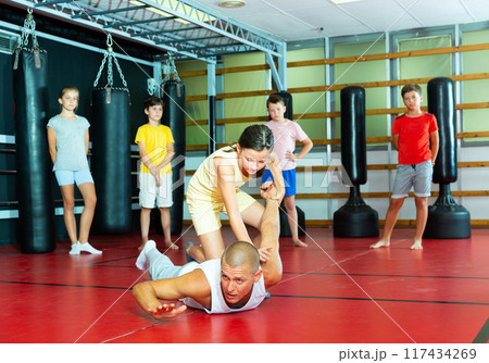 Girl practice self-defense techniques on trainer Girl practice self-defense techniques on trainer 117434269