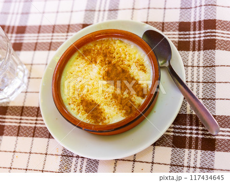 Rice pudding. Sweet dish made by cooking rice in milk and sugar, some recipes include vanilla 117434645