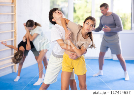 Boy and girl practicing self-defense techniques Boy and girl practicing self-defense techniques 117434687