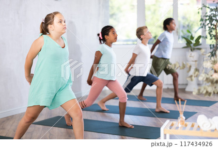 Young girl doing pilates in group of children 117434926