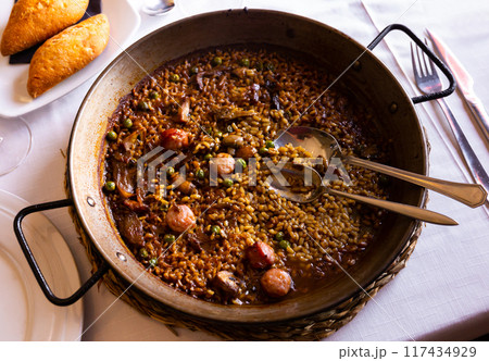 Traditional spanish paella with mushrooms and sausage butifarra Traditional spanish paella with mushrooms and sausage butifarra 117434929