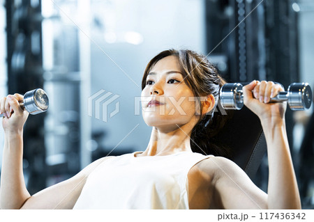 スポーツジムでトレーニングする若い女性 スポーツジムでトレーニングする若い女性 117436342