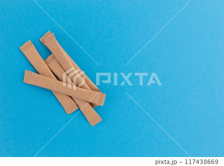 sugar packets on blue background, top view sugar packets on blue background, top view 117438669