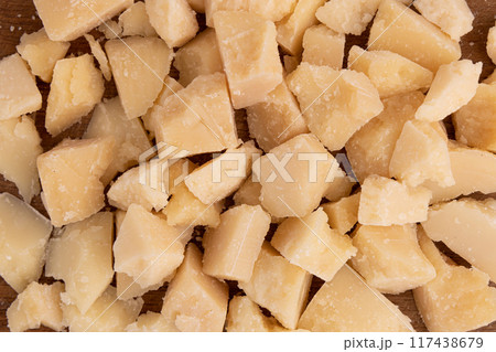 pieces of parmesan cheese as background, close up 117438679