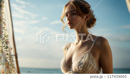 Beach inspired scene with model in light airy lingerie breezy fabric seaside studio illusion tranquil 117439005