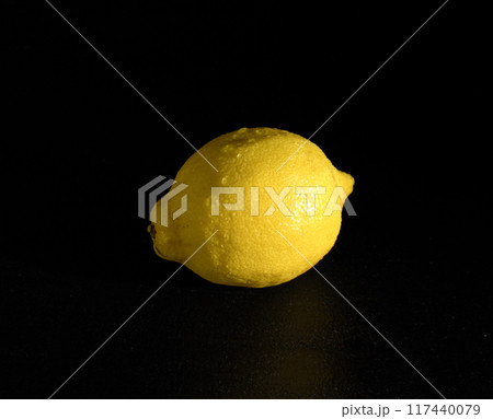 Ripe Yellow Lemon on a Black Background 117440079