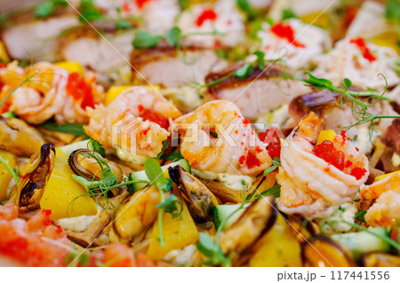 A box with an assortment of meat and fish appetizers for the buffet table.  117441556