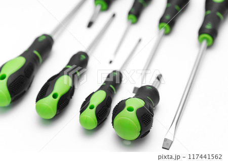 green plastic screwdriver handles on a white background. green plastic screwdriver handles on a white background. 117441562