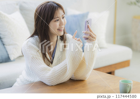 部屋でくつろぐニットの若い女性 部屋でくつろぐニットの若い女性 117444580