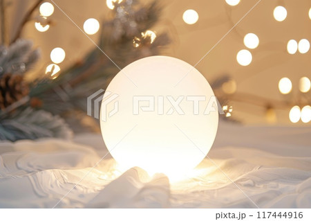 Festive White Christmas Ornament with Sparkling Lights Bokeh Background Festive White Christmas Ornament with Sparkling Lights Bokeh Background 117444916