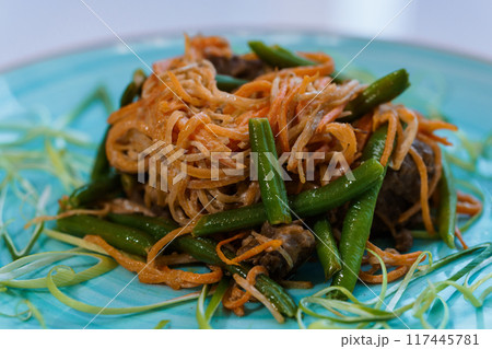 Meat stew with carrots and green beans asparagus on a plate Meat stew with carrots and green beans asparagus on a plate 117445781