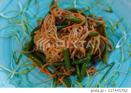 Meat stew with carrots and green beans asparagus on a plate Meat stew with carrots and green beans asparagus on a plate 117445782