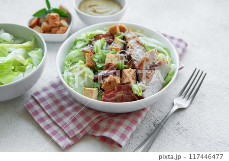 A bowl  of  Caesar salad 117446477