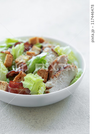 A bowl  of  Caesar salad 117446478