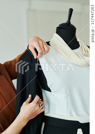 Trying unfinished suit on mannequin 117447263