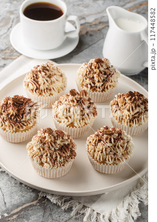Tiramisu Cupcakes with Mascarpone cocoa Frosting closeup on the plate. Vertical 117448582