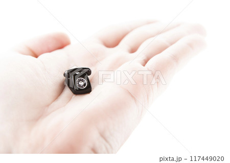 image of miniature phone hand white background 117449020
