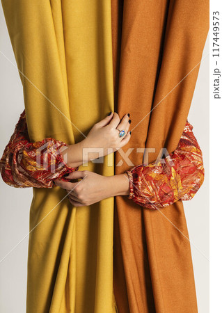 hands of a creator, carefully holding fabrics, represent the artistry involved in textile design, Autumn Elegance hands of a creator, carefully holding fabrics, represent the artistry involved in textile design, Autumn Elegance 117449573