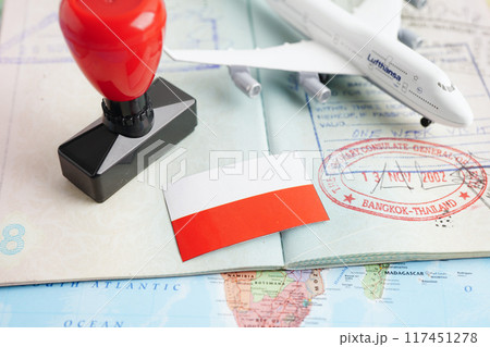 Bangkok, Thailand December 10, 2023 Republic of Poland visa and passport with airplane and flag on white background with copy space. Bangkok, Thailand December 10, 2023 Republic of Poland visa and passport with airplane and flag on white background with copy space. 117451278