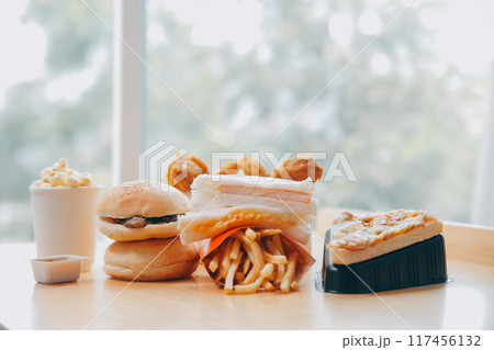 Closeup of home made burgers on wooden background Closeup of home made burgers on wooden background 117456132