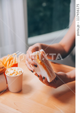 Asian healthy woman have breakfast with sandwich in morning 117456175