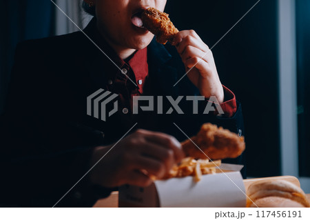 close up focus woman hand hold fried chicken for eat,girl with fast food concept close up focus woman hand hold fried chicken for eat,girl with fast food concept 117456191