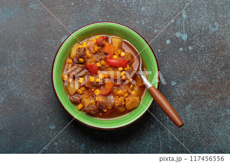Carbonada Criolla, Argentinian beef casserole stew in bowl with serving spoon top view Carbonada Criolla, Argentinian beef casserole stew in bowl with serving spoon top view 117456556