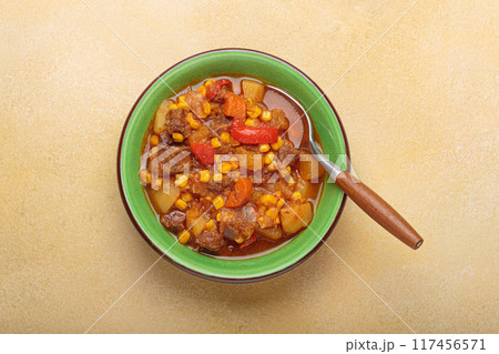 Carbonada Criolla, Argentinian beef casserole stew in bowl with serving spoon top view 117456571