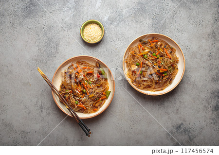 Two bowls of japchae, korean glass noodles stir fry with vegetables and mushrooms 117456574