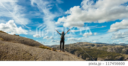 Woman successful hiking silhouette in mountains, motivation and inspiration in beautiful sunset. Female hiker with arms up outstretched on mountain top, inspirational landscape 117456600
