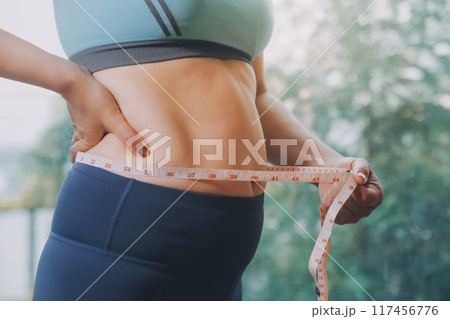 fat woman, fat belly, chubby, obese woman hand holding excessive belly fat with measure tape, woman diet lifestyle concept fat woman, fat belly, chubby, obese woman hand holding excessive belly fat with measure tape, woman diet lifestyle concept 117456776
