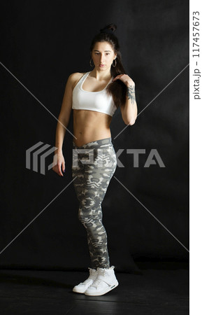 Beautiful athletic girl on a dark background Beautiful athletic girl on a dark background 117457673