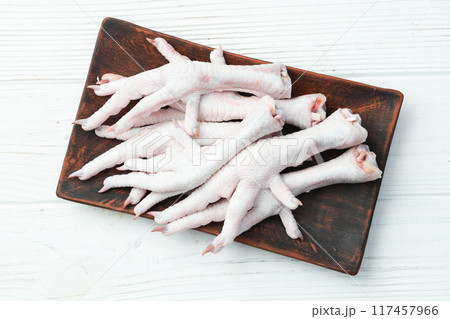 Raw chicken foot ( paws ) Top view on rustic background Raw chicken foot ( paws ) Top view on rustic background 117457966
